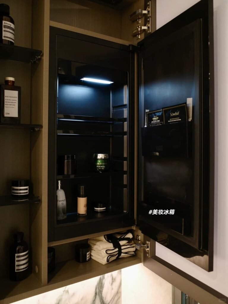 Modern medicine cabinet with hidden storage shelves inside a small bathroom.