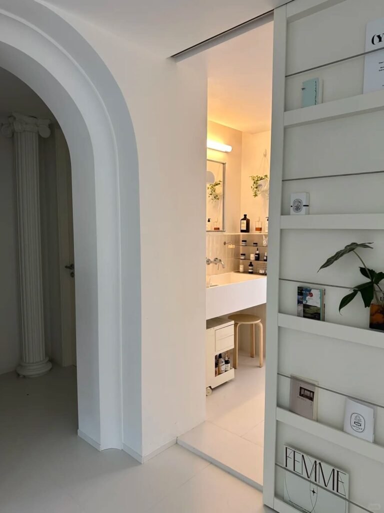 Modern pocket bathroom door saving floor space in a compact bathroom layout.
