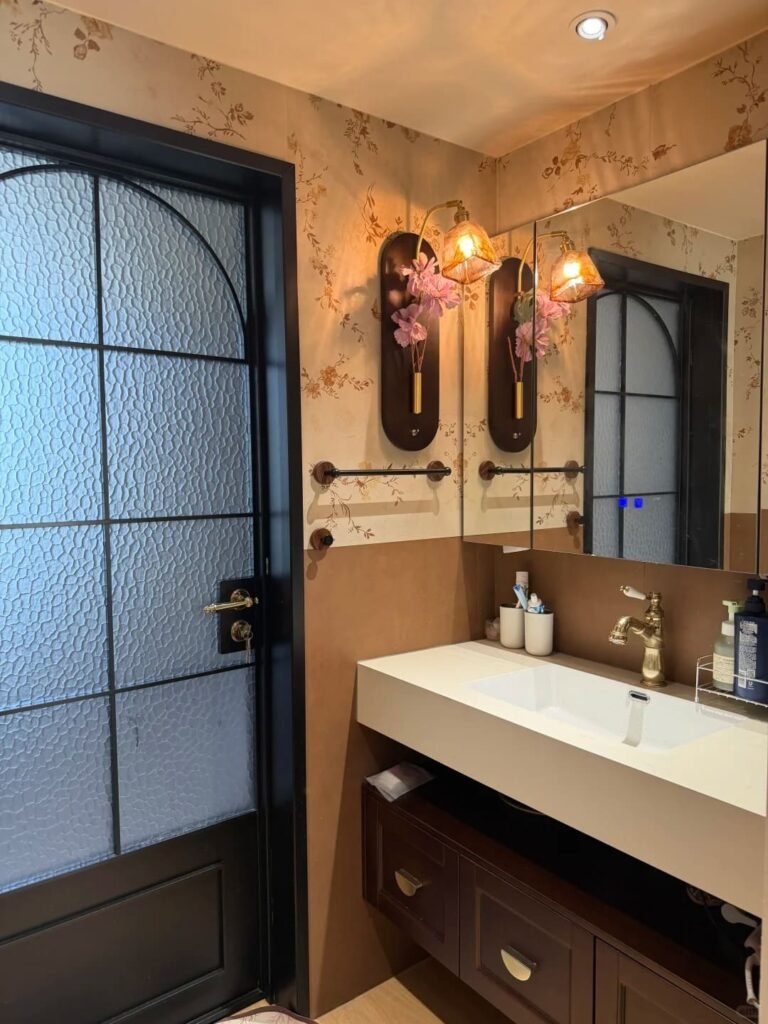 Pair of wall sconces mounted on each side of a bathroom mirror for balanced lighting.