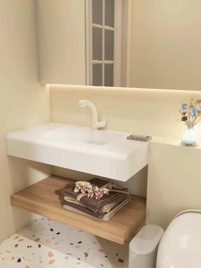 Wall-mounted floating bathroom vanity with under-cabinet lighting in a compact bathroom.