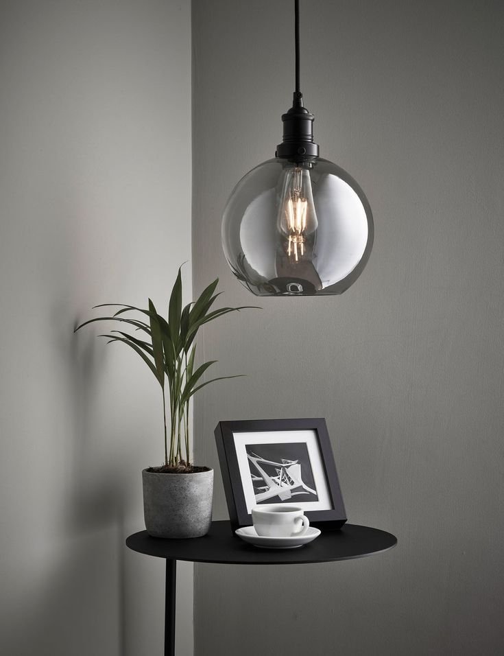 Hand-blown smoked glass globe with a smooth, round shape and subtle gray-brown tint, softly diffusing warm light to create a cozy, artisanal ambiance - Bedroom Lighting Ideas.