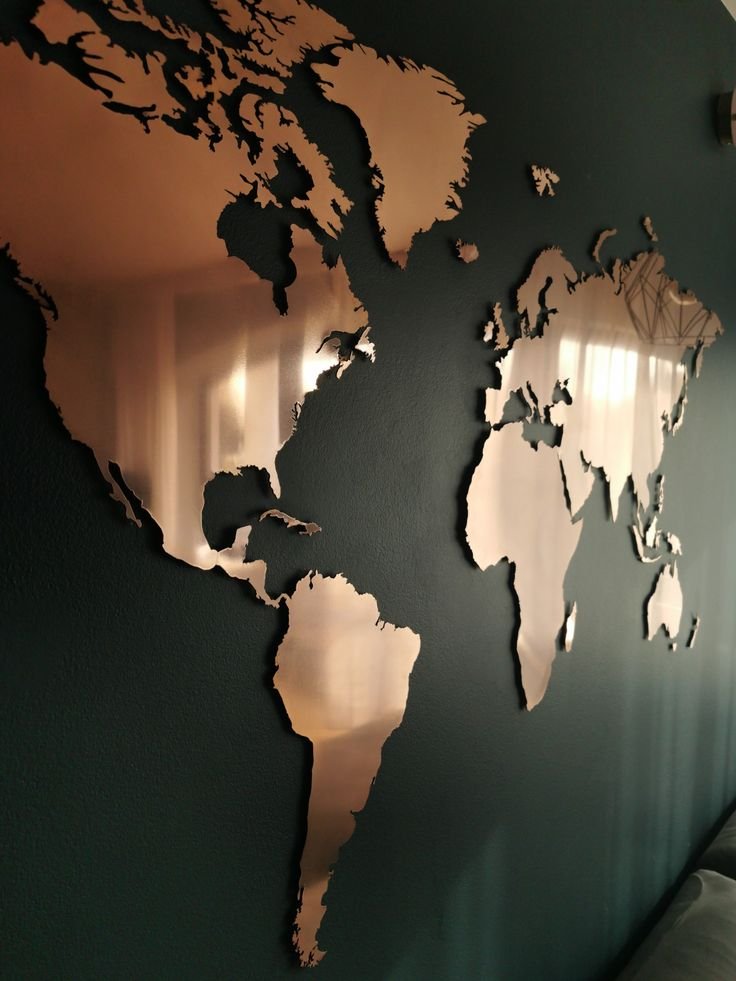 Laser-cut copper metal world map wall decor for a modern, masculine bedroom.