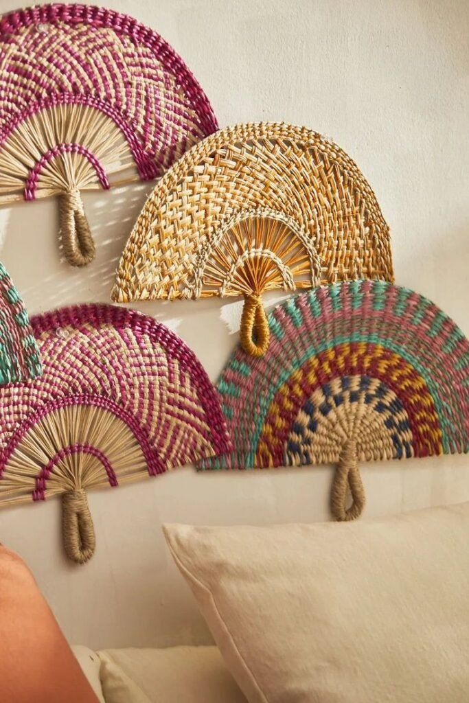 Decorative woven seagrass wall fans are arranged in a cluster as a headboard alternative.