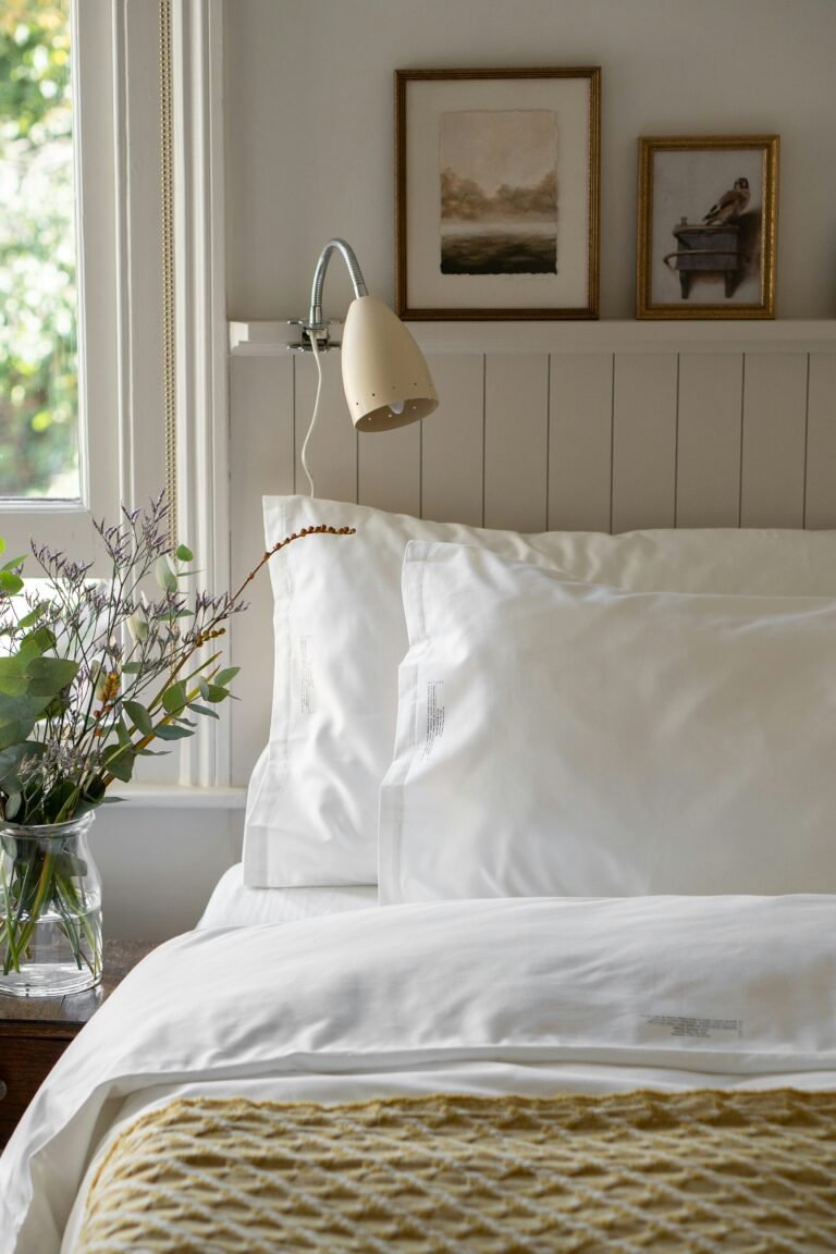 Minimalist aesthetic bedroom with white organic cotton bedding and soft morning sunlight