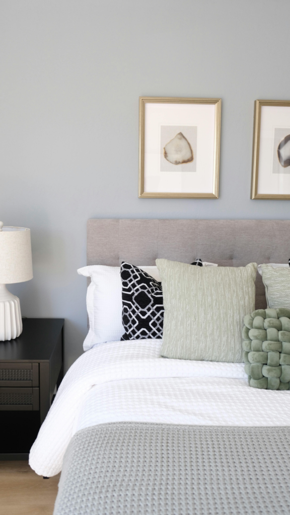 Bedsure 100% cotton waffle weave duvet cover in white styled with sage green pillows in a modern airy bedroom.