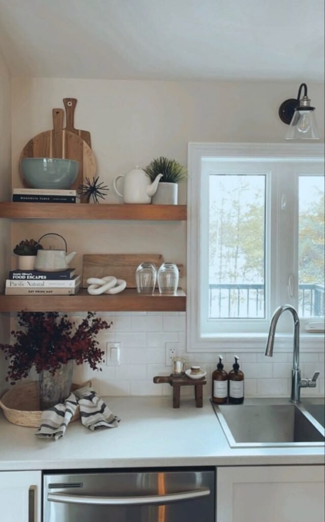 Floating shelves above the counter, displaying mugs and jars as vertical kitchen counter decor