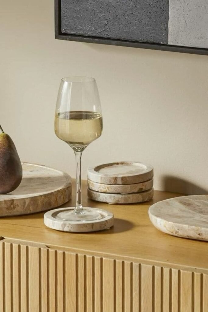 Artful slate coaster under a water glass, protecting the surface while enhancing kitchen counter decor