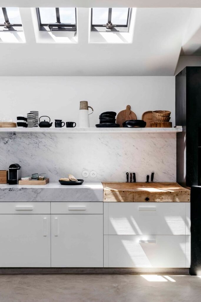 Butcher block extension adding warmth and extra surface for layered kitchen counter decor
