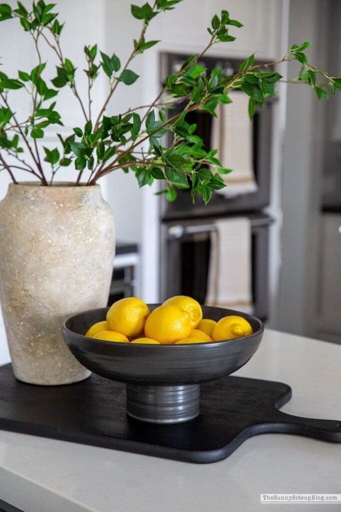 Art-directed fruit bowl with green apples and lemons 
