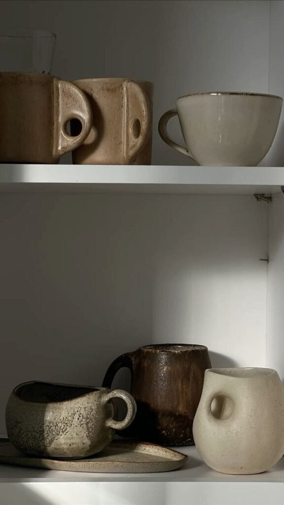 Hand-thrown ceramic vase and bowl introducing organic texture to kitchen counter decor
