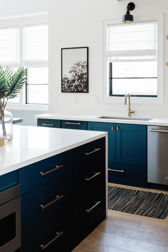 Blue kitchen cabinets in varied tones from powder blue to peacock, paired with warm brass and natural wood accents
