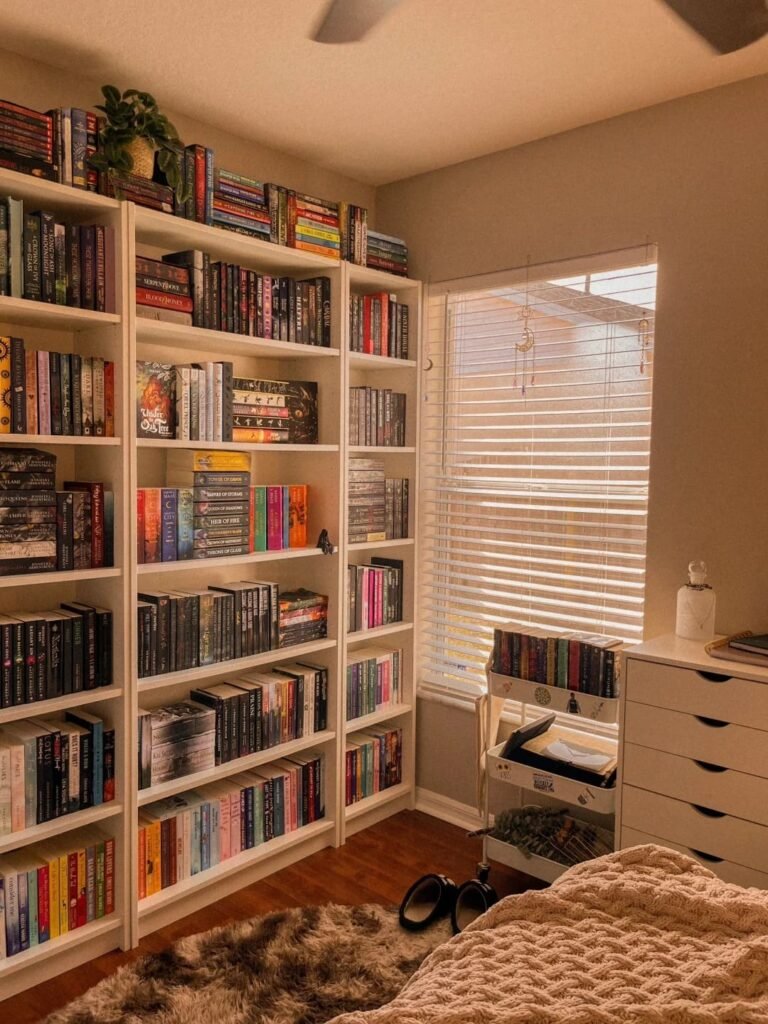 Home workspace bookshelf organized by color to create a beautiful rainbow library wall display.