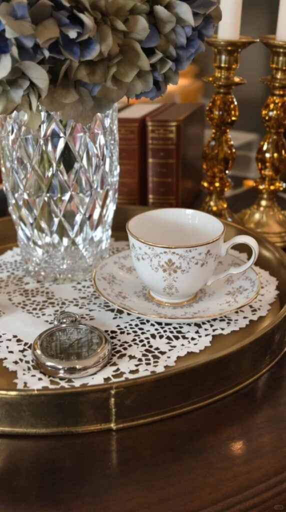Coffee table styled with a decorative tray holding candles, books, and small accessories for an organized look.