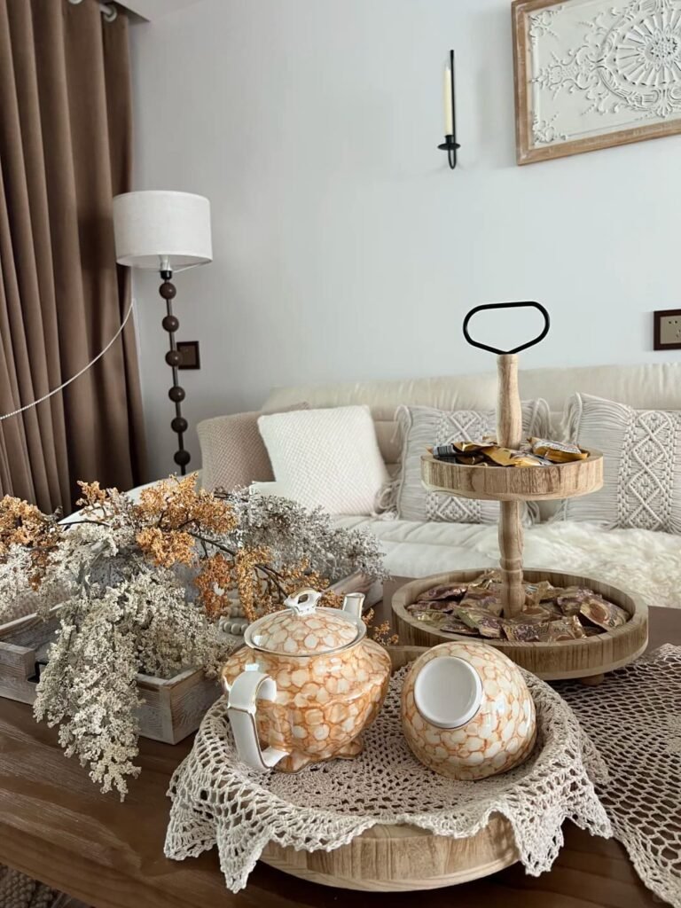 Coffee table styled with a linen runner layered beneath decorative objects for added texture.
