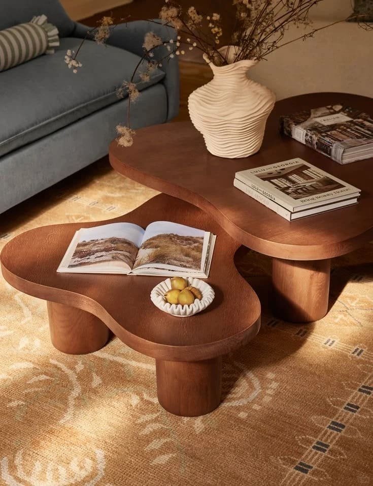 Modern coffee table ideas featuring layered decor with books, candles, greenery, and decorative accents in a cozy living room.