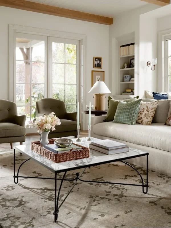 Stylish coffee table ideas with a wooden coffee table decorated using minimalist accessories in a bright living room.